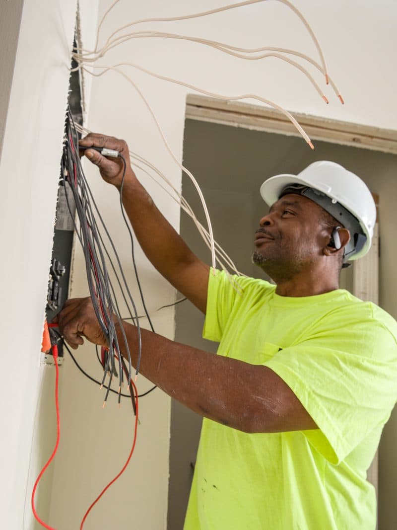 Brady electrician wiring a panel